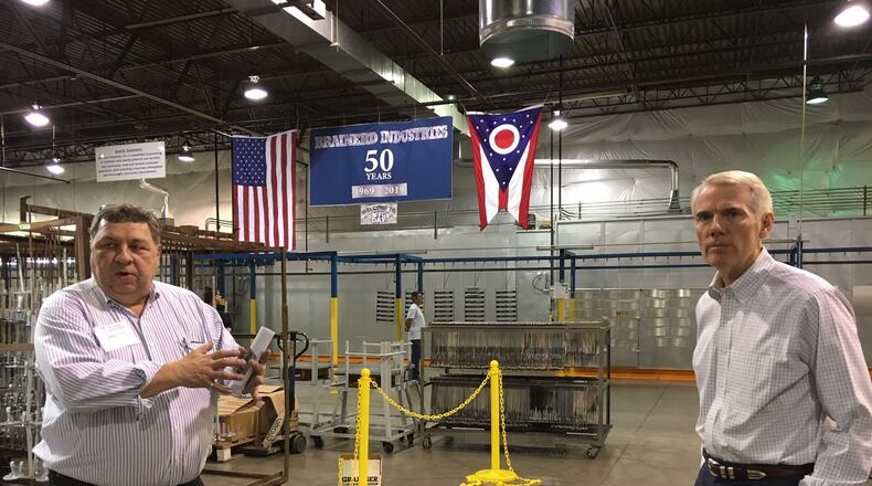 Gregory Fritz, left, president of Brainerd Industries, shows Sen. Rob Portman, R-Ohio, around his Precision Court production facility last week. THOMAS GNAU/STAFF