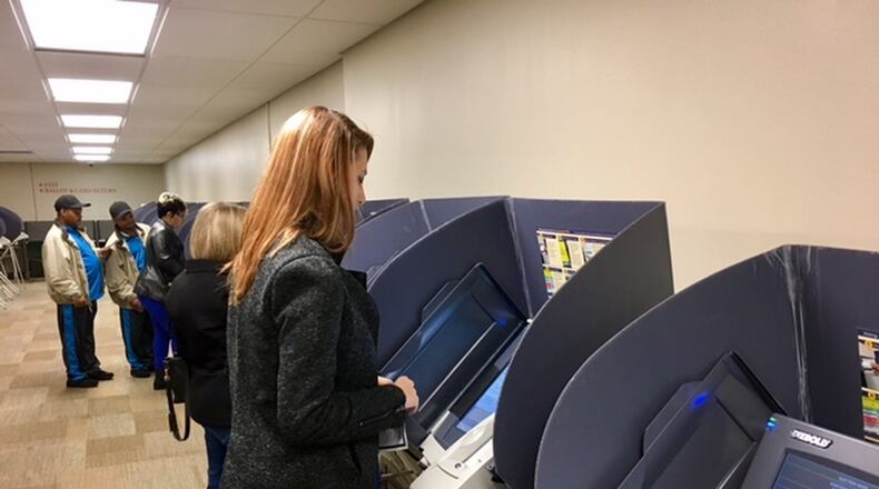 Ashley Jenkins, 32, of Dayton votes on Oct. 21 at the Montgomery County Board of Elections. LYNN HULSEY/staff