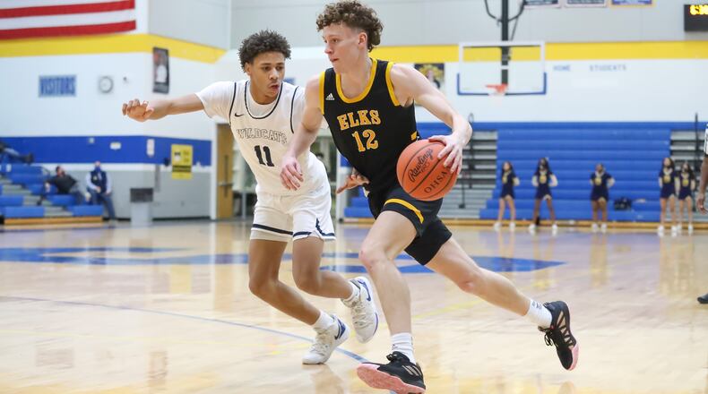Cutline: Centerville High School junior Tom House drives by Springfield junior Eddie Muhammad during their game on Wednesday night in Springfield. Michael Cooper/CONTRIBUTED