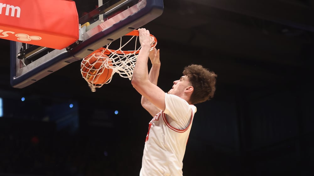 Dayton's Amaël L'Etang dunks against Liberty on Saturday, Dec. 20, 2025, at UD Arena. David Jablonski/Staff