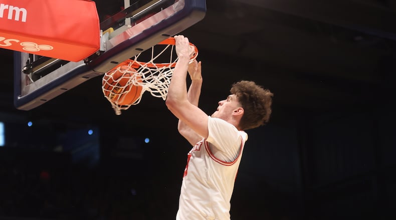 Dayton's Amaël L'Etang dunks against Liberty on Saturday, Dec. 20, 2025, at UD Arena. David Jablonski/Staff