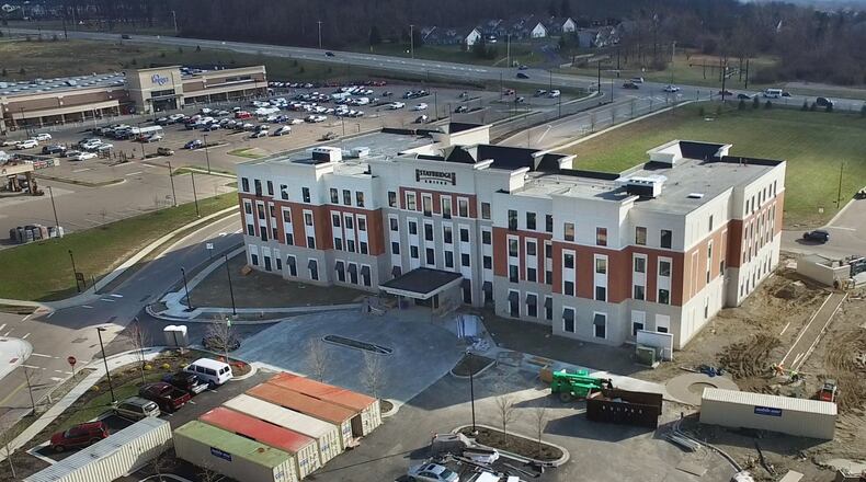 The $12 million Staybridge Inn & Suites in the final stages of construction before it opened for business last month near the The Flats and Kohls. The hotel is part of a hotel building boom in the Dayton area. The four-story, 108 room hotel has an indoor pool, a cabana, a guest laundry, a business center, a fitness room, a fire pit and a courtyard. TY GREENLEES / STAFF