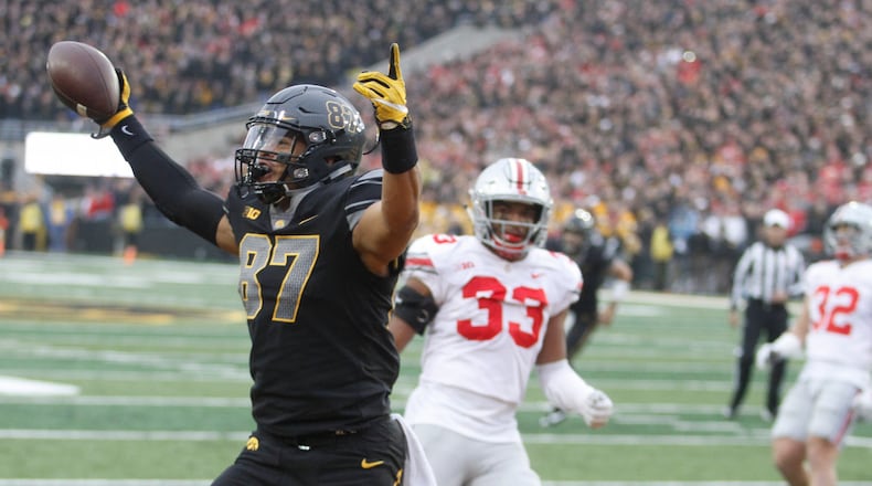 IOWA CITY, IOWA- NOVEMBER 04:  Tight end Noah Fant #87 of the Iowa Hawkeyes celebrates a touchdown during the second quarter in front of linebacker Dante Booker #33 of the Ohio State Buckeyes on November 04, 2017 at Kinnick Stadium in Iowa City, Iowa.  (Photo by Matthew Holst/Getty Images)