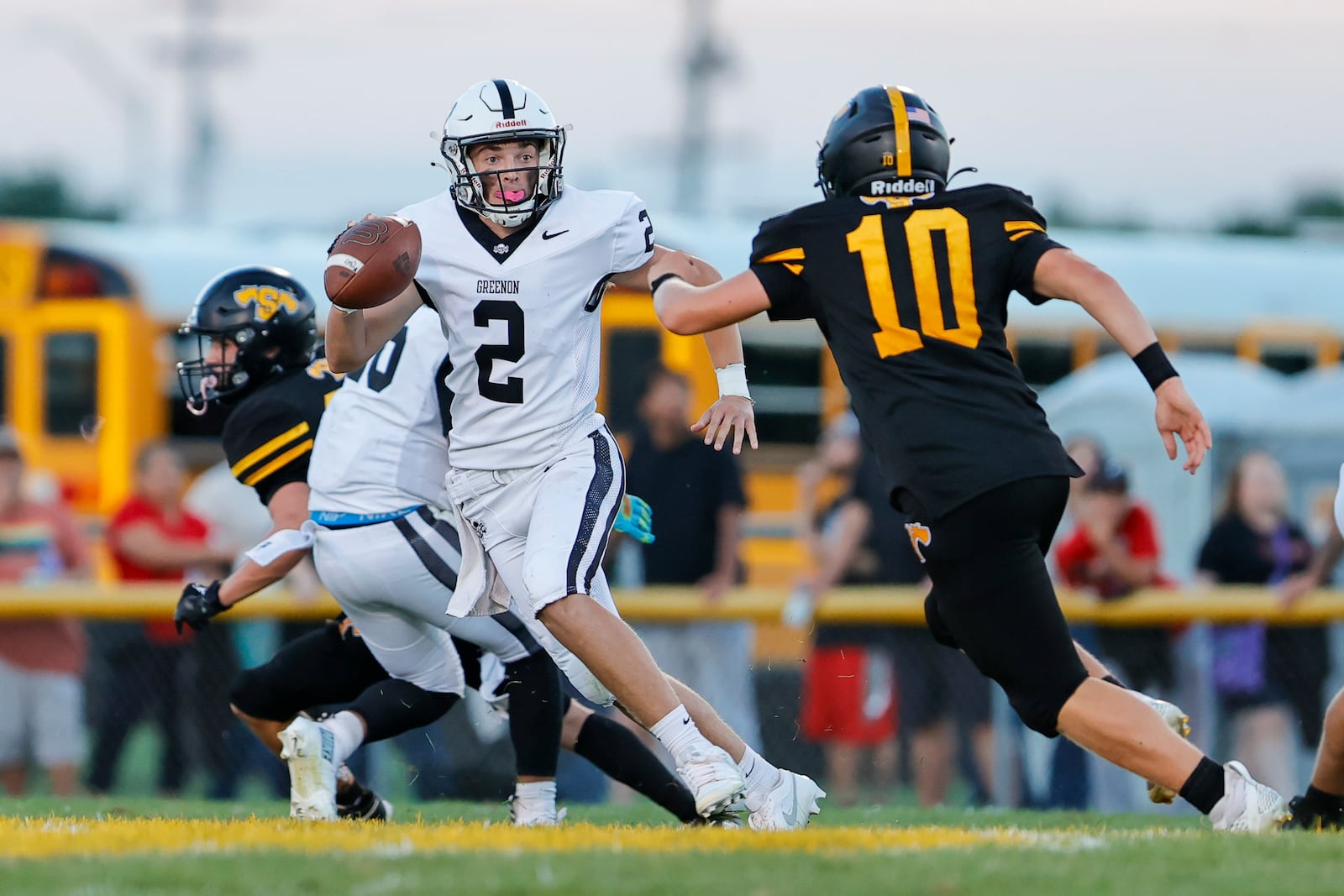 Greenon High School junior quarterback Teagan Henry attempts to run past Shawnee High School sophomore Caleb Coppess during their game on Friday, Aug. 22 in Springfield. The Knights won 34-14. MICHAEL COOPER/STAFF