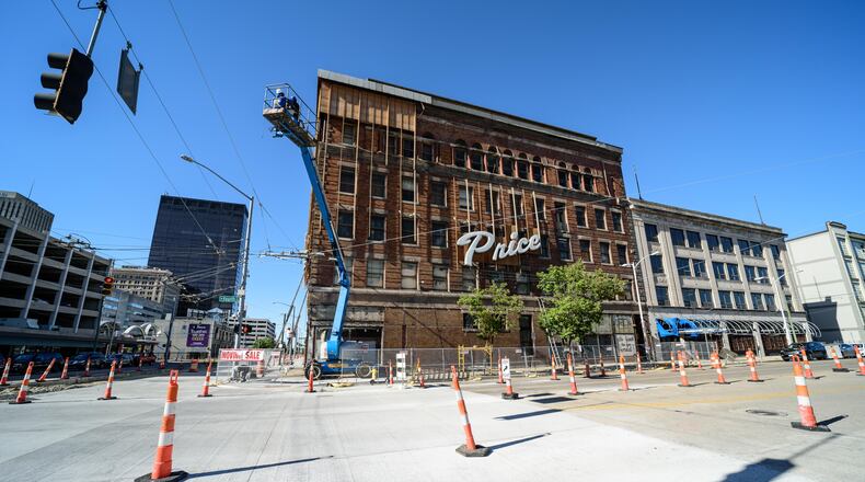 Price Stores, located at 52 S. Jefferson St. in downtown Dayton since its beginning in 1950, is moving to Centerville. Work continues on the building's facade, as seen in this file photo.  TOM GILLIAM/CONTRIBUTED