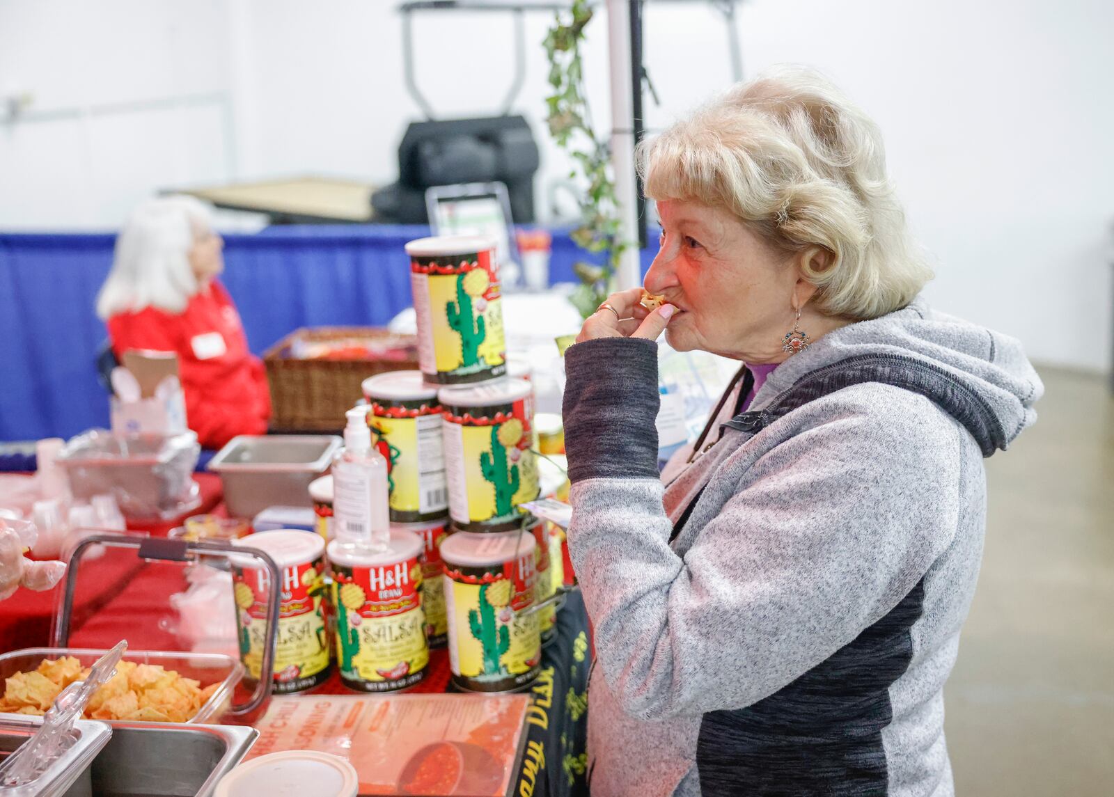 Jo Rardon, of Springfield, eats a chip from H&H Brands, Inc. booth during the Clark County Home and Garden Show. JOSEPH COOKE/STAFF