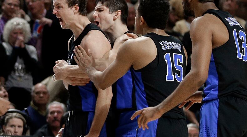 Duke’s Luke Kennard, left, and Duke’s Grayson Allen, second from left, celebrate with teammates after Kennard’s game-winning basket against Wake Forest in the second half of an NCAA basketball game in Winston-Salem, N.C., Saturday, Jan. 28, 2017. Duke won 85-83. (AP Photo/Chuck Burton)