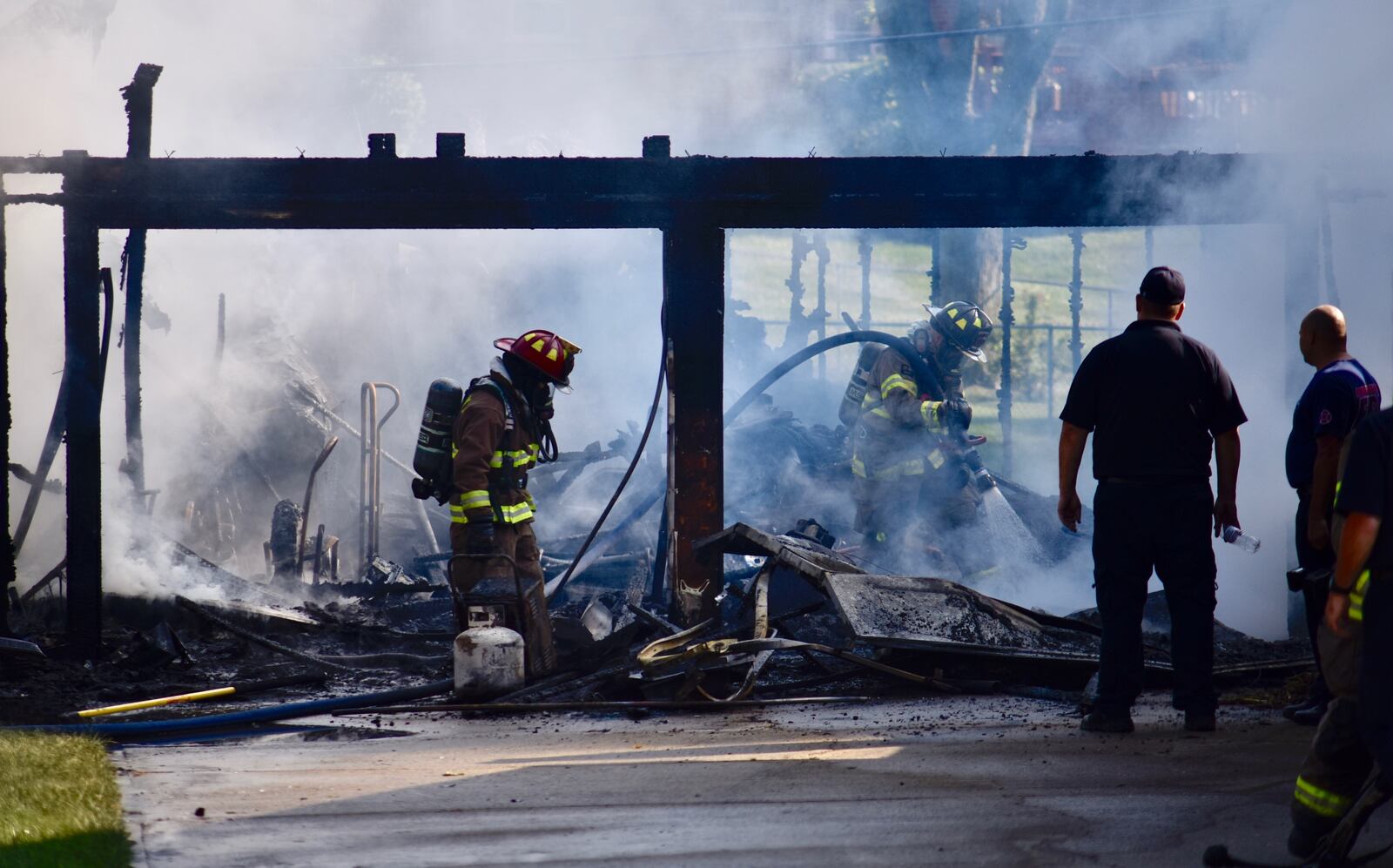Firefighters work to extinguish a fire inside a detatched garage in Middletown Wednesday monring. Crews were dispatched at 8:40 a.m. to a garage engulfed in flames. NICK GRAHAM/STAF