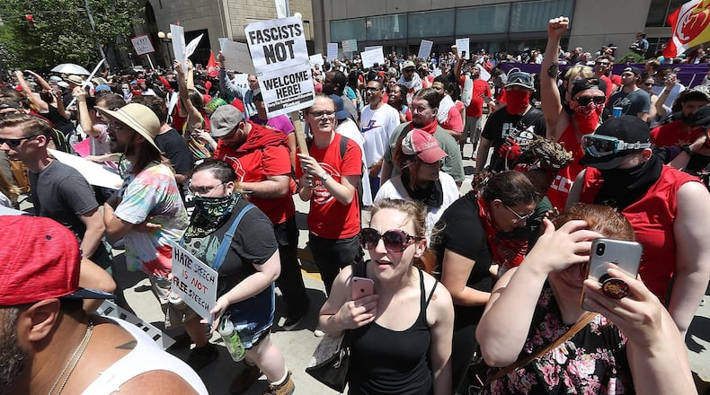 Hundreds of protesters rallied together against hate Saturday along Main Street in Downtown Dayton. BILL LACKEY/STAFF