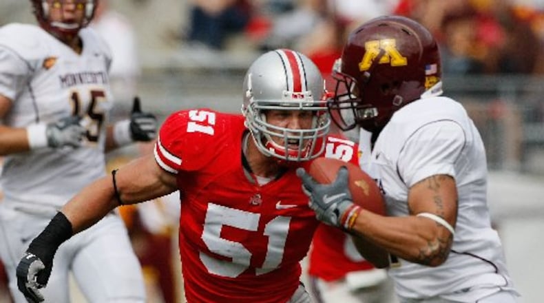 Ohio State's Ross Homan, 51, goes after Minnesota's Eric Decker, 7, in the second half of their game at The Ohio Stadium, September 27, 2008. (Dispatch photo by Neal C. Lauron)