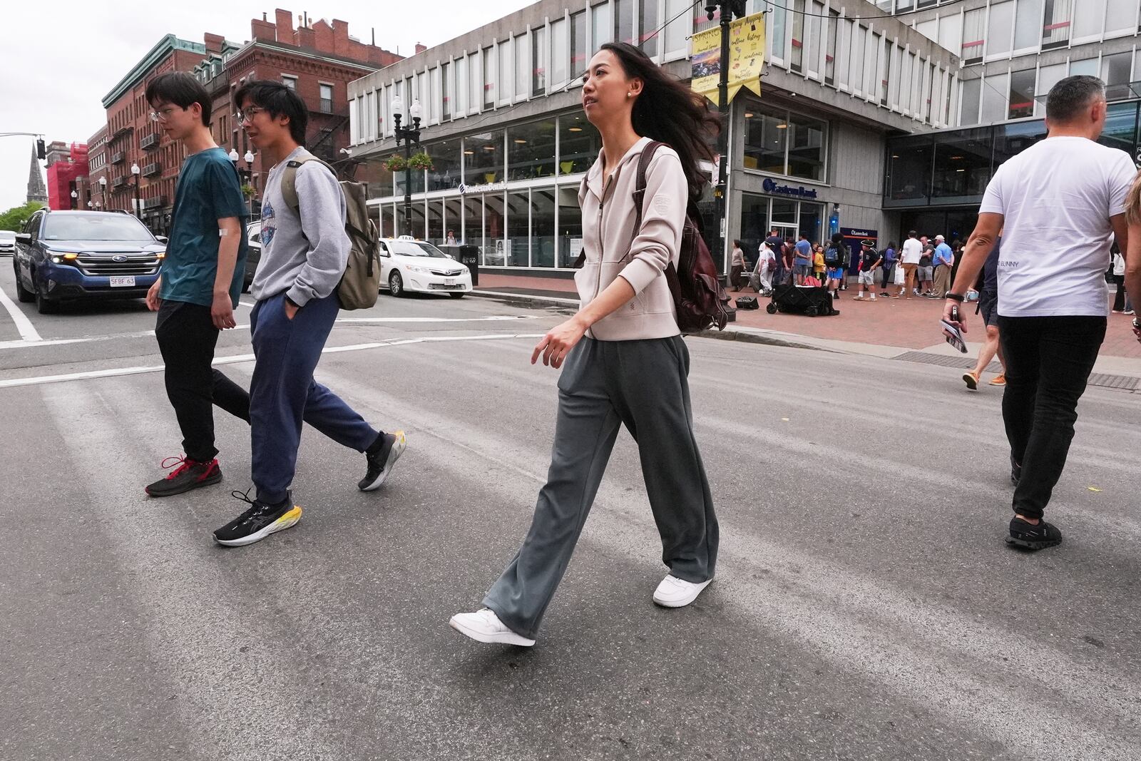 Yurong "Luanna" Jiang, who delivered a speech at her Harvard University commencement, crosses Massachusetts Avenue near the gates of Harvard Yard, Friday, May 30, 2025, in Cambridge, Mass. (AP Photo/Charles Krupa)