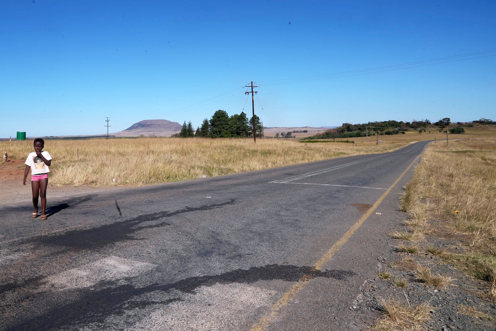 A young girl walks in Normandien, a rural area in KwaZulu-Natal province, South Africa, May 23, 2025. (AP Photo/Alfonso Nqunjana)