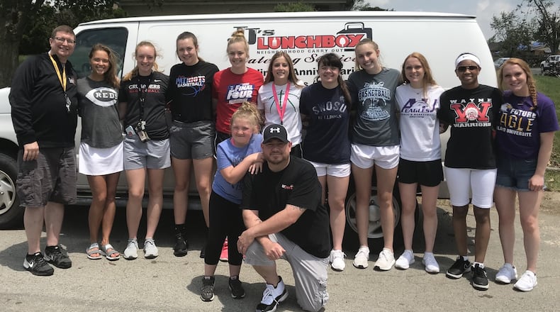 A group of local basketball players pose for a photo after handing out hot meals in the Shiloh Gardens neighborhood in Trotwood six days after the Miami Valley tornadoes. Back row (left to right): Jim Dabbelt, Rosie Westerbeck, Allie Downing, Meghan Downing, Maddie Downing, Haleigh Mayo-Behnken, Lauren Hapgood, Callie Hunt, Sam Chable, Nyla Hampton, Shannon Chable. Front row: Kennedy Pierce, Jason Pierce. Submitted photo