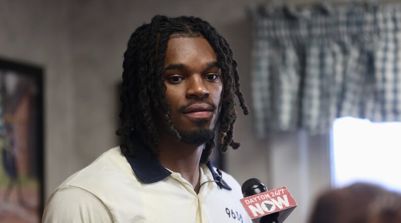 DaRon Holmes II talks to reporters during an autograph signing for Dayton fans at Lee's Famous Recipe Chicken in Kettering on Thursday, July 31, 2025. David Jablonski/Staff