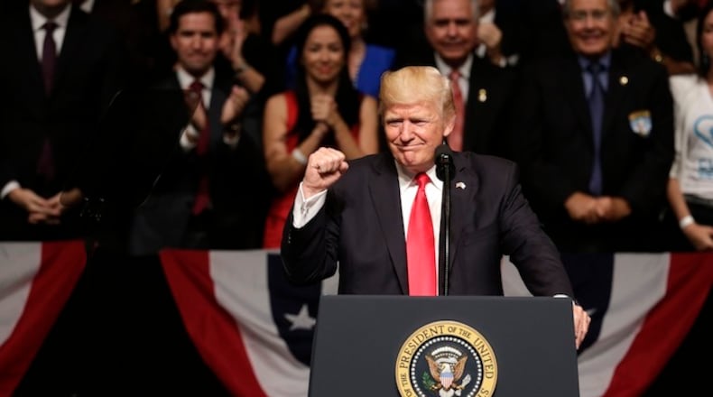 President Donald Trump clenches his fist as he announces a revised Cuba policy aimed at stopping the flow of U.S. cash to the country's military and security services while maintaining diplomatic relations, Friday, June 16, 2017, in Miami. (AP Photo/Lynne Sladky)