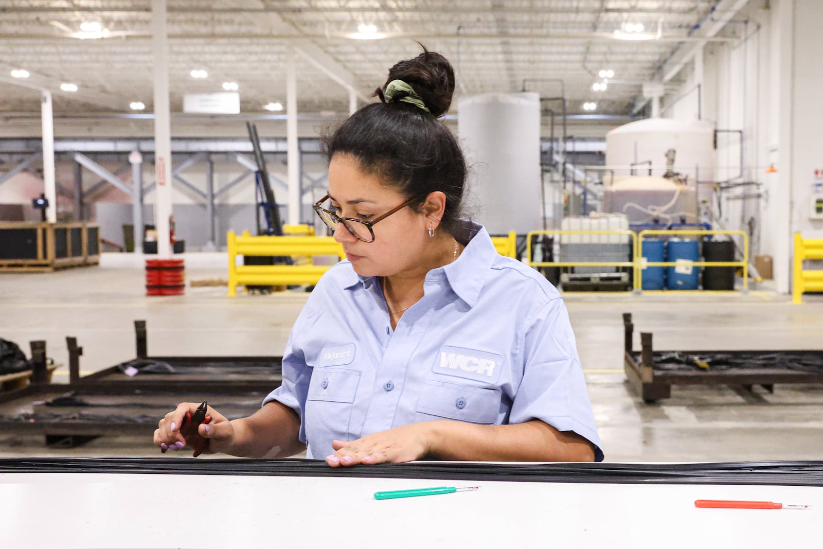 A staff member at WCR cuts a rubber gasket to size at the company's Xenia factory. WCR Inc. has recently moved into its new corporate headquarters in Xenia. BRYANT BILLING / STAFF