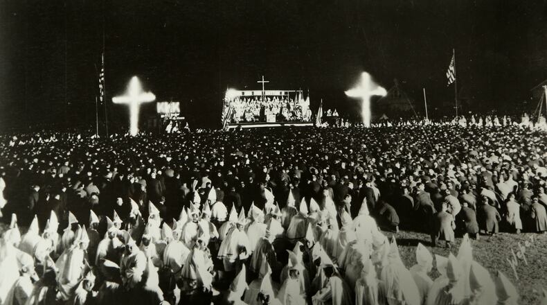 On Sept. 21, 1923, after a parade through the downtown that had sidewalks packed with cheering spectators, Klan held a “naturalization ceremony, at Fairgrounds. Some 15,000 members, were joined by some 7,000 initiates from around the state as 10,000 spectators watched from the grandstand. A 100-foot high cross was set ablaze, there was a fireworks display and overhead a Klan plane circled with a red cross in electric lights on its side. In this time, the target of the Klan – even more so than the immigrants who had come to town to work at NCR and Delco – was the University of Dayton and its “Catholics.” The Klan burned numerous crosses on UD property and harassed students. COPIED FROM A PHOTO (UD history professor Dr. William Vance Trollinger Jr.) OBTAINED FROM THE DAYTON METRO LIBRARY