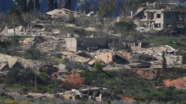 An Israeli tank maneuvers in southern Lebanon near the border with Israel, Sunday, March 8, 2026. (AP Photo/Ariel Schalit)