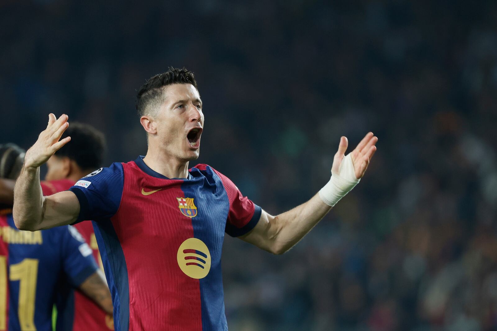 Barcelona's Robert Lewandowski celebrates after scoring his side's second goal during the Champions League quarterfinals first leg soccer match between Barcelona and Borussia Dortmund, at the Lluis Companys Olympic stadium in Barcelona, Spain, Wednesday, April 9, 2025. (AP Photo/Joan Monfort)