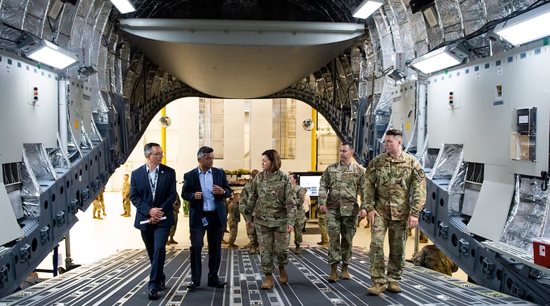 Chief Master Sgt. of the Air Force JoAnne Bass is briefed on the En-Route Care Training Program as she walks up the back of a training C-17 fuselage during her visit to the U.S. Air Force School of Aerospace Medicine at Wright-Patterson Air Force Base on June 3. A 3-day base tour brought Bass to several units within the 88th Air Base Wing, Air Force Materiel Command, Air Force Life Cycle Management Center and Air Force Research Laboratory. U.S. AIR FORCE PHOTO/WESLEY FARNSWORTH