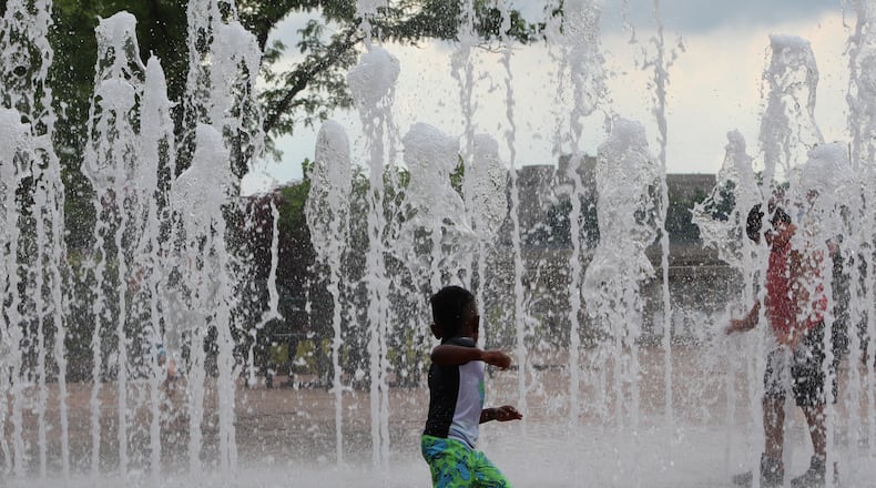 Kids play in the fountain at RiverScape MetroPark in downtown Dayton in 2018. CORNELIUS FROLIK / STAFF