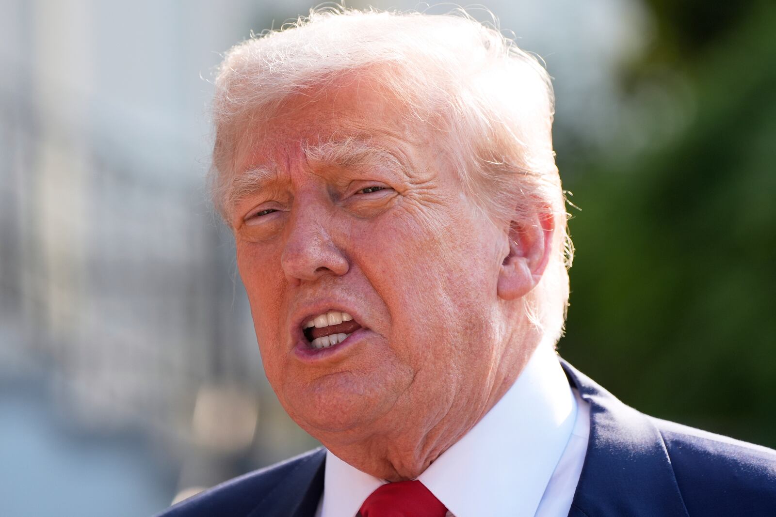 President Donald Trump speaks with reporters before departing on Marine One from the South Lawn of the White House, Friday, July 25, 2025, in Washington. The President is traveling to Scotland. (AP Photo/Alex Brandon)
