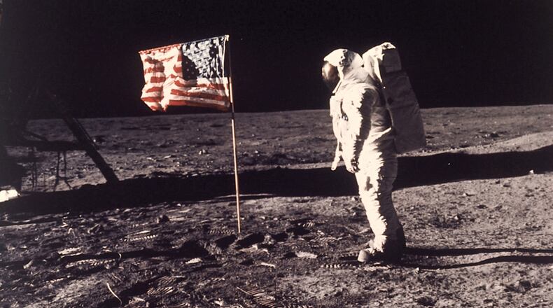 This July 20, 1969 file photo shows astronaut Edwin E. "Buzz" Aldrin Jr.  standing beside the U.S. flag deployed on the moon during the Apollo 11 mission.  (AP Photo/Neil Armstrong, NASA, File)