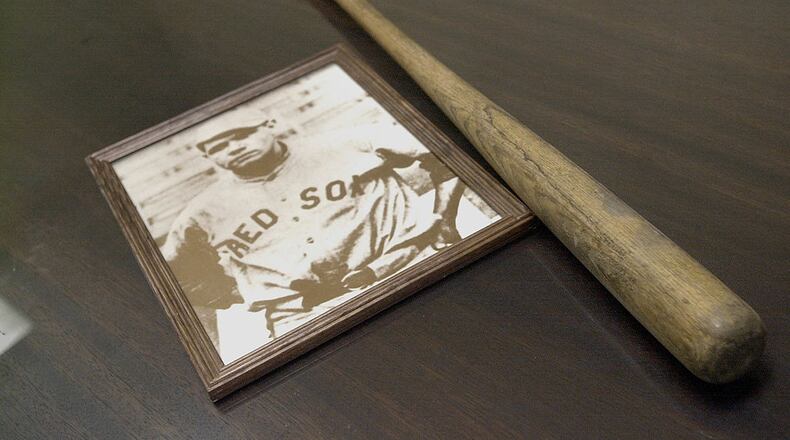 393274 05: A vintage photo and practice bat belonging to legendary ballplayer Herman "Babe" Ruth sit on a table August 15, 2001 during a press conference to announce a public initiative to honor Ruth in Boston, MA. Ruth led the 1918 Red Sox to a World Series, but was traded the following year to the rival New York Yankees. Since then the Red Sox have gone 82 seasons without another championship. The drought has become known locally as the "Curse of the Bambino." The public initiative to honor Ruth is also designed to lift the curse. Red Sox management have never honored Ruth and will not participate in the September ceremony. (Photo by Darren McCollester/Getty Images)