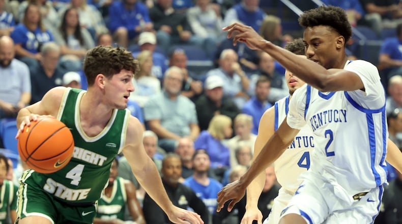 Wright State's Keaton Norris (4) looks for an opening against Kentucky's Jaxson Robinson (2) during the first half of an NCAA college basketball game in Lexington, Ky., Monday, Nov. 4, 2024. (AP Photo/James Crisp)