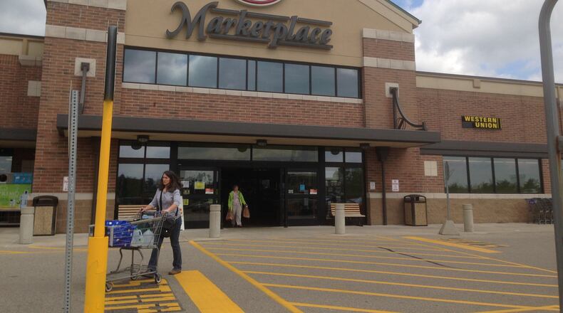 A shopper exits Kroger Marketplace on Yankee Road in Liberty Twp. STAFF FILE PHOTO
