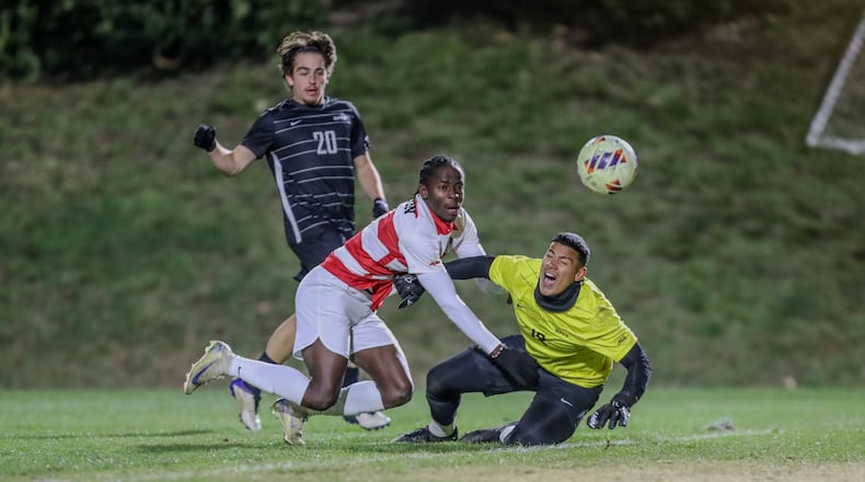 University of Dayton senior midfielder Joseph Melto Quiah pushes a shot past Southern Methodist University junior goalkeeper Martin Dominguez during an NCAA third-round game on Saturday night at Baujan Field in Dayton. The Mustangs won 3-1. Michael Cooper/CONTRIBUTED