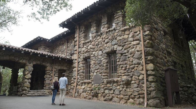 A couple read the historic marker on the wall of the ‘House of Happy Walls’ museum at Jack London State Historic Park on May 5, 2016 in Glen Ellen, Calif. (Randy Pench/Sacramento Bee/TNS)
