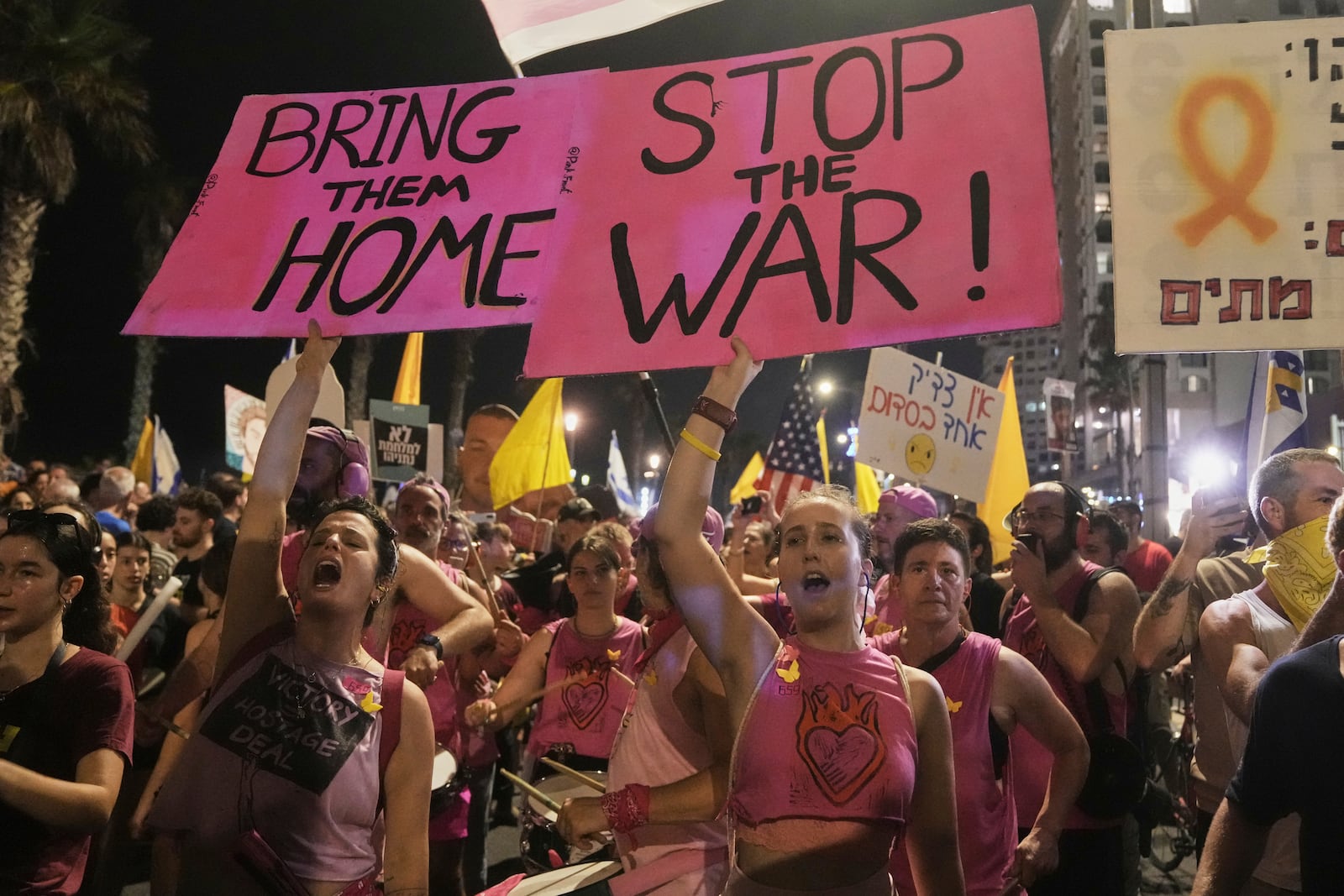 People take part in a protest outside US Embassy Branch demanding the end of the war and immediate release of hostages held by Hamas in the Gaza Strip, and against Prime Minister Benjamin Netanyahu's government in Tel Aviv, Saturday, July 26, 2025. (AP Photo/Mahmoud Illean)