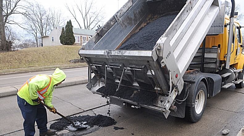 Local officials say potholes are worse this year than the past two winters. A Dayton crew patches a pothole on Gettysburg Ave. MARSHALL GORBY