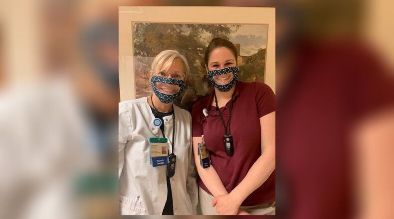 Two Atrium Medical Center speech therapists, from left, Tracey Wells and Katie Hanak wear special masks that were donated by Diana Unger. The masks allow a person with hearing disabilities to read lips. SUBMITTED PHOTO