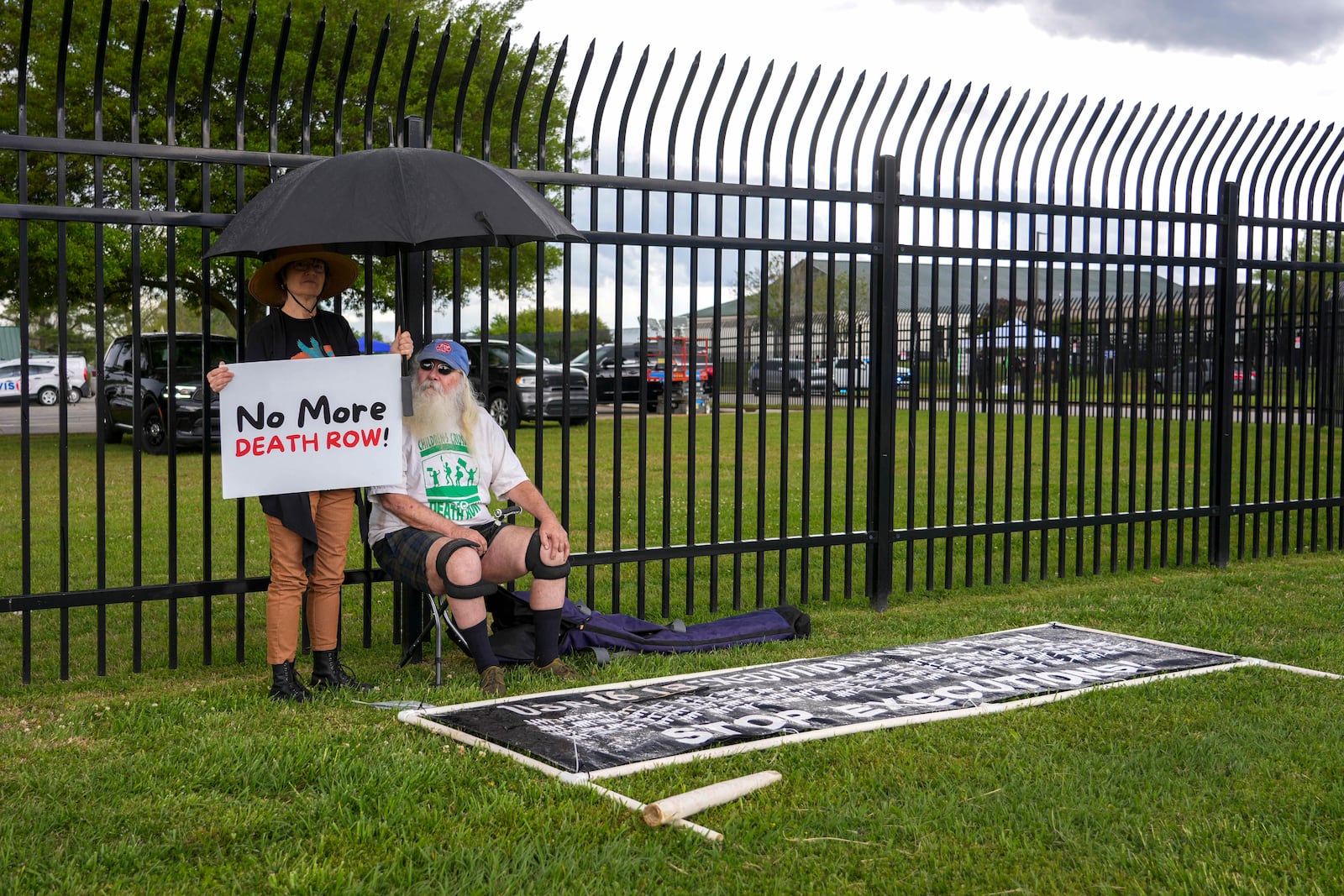 Protestors Noel Nickel, left, and Ron Kaz demonstrate in the rain outside the scheduled execution of South Carolina inmate Mikal Mahdi in Columbia, S.C., Friday, April 11, 2025. (AP Photo/David Yeazell)