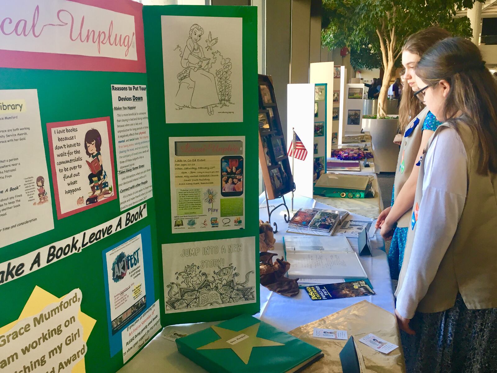 Local Girl Scouts look over the projects that won Gold Awards this year, the top honor for high school Girl Scouts. 21 Dayton-area Girl Scouts received the award this year and were honored at a ceremony at Sinclair Community College Sunday, March 4, 2018.