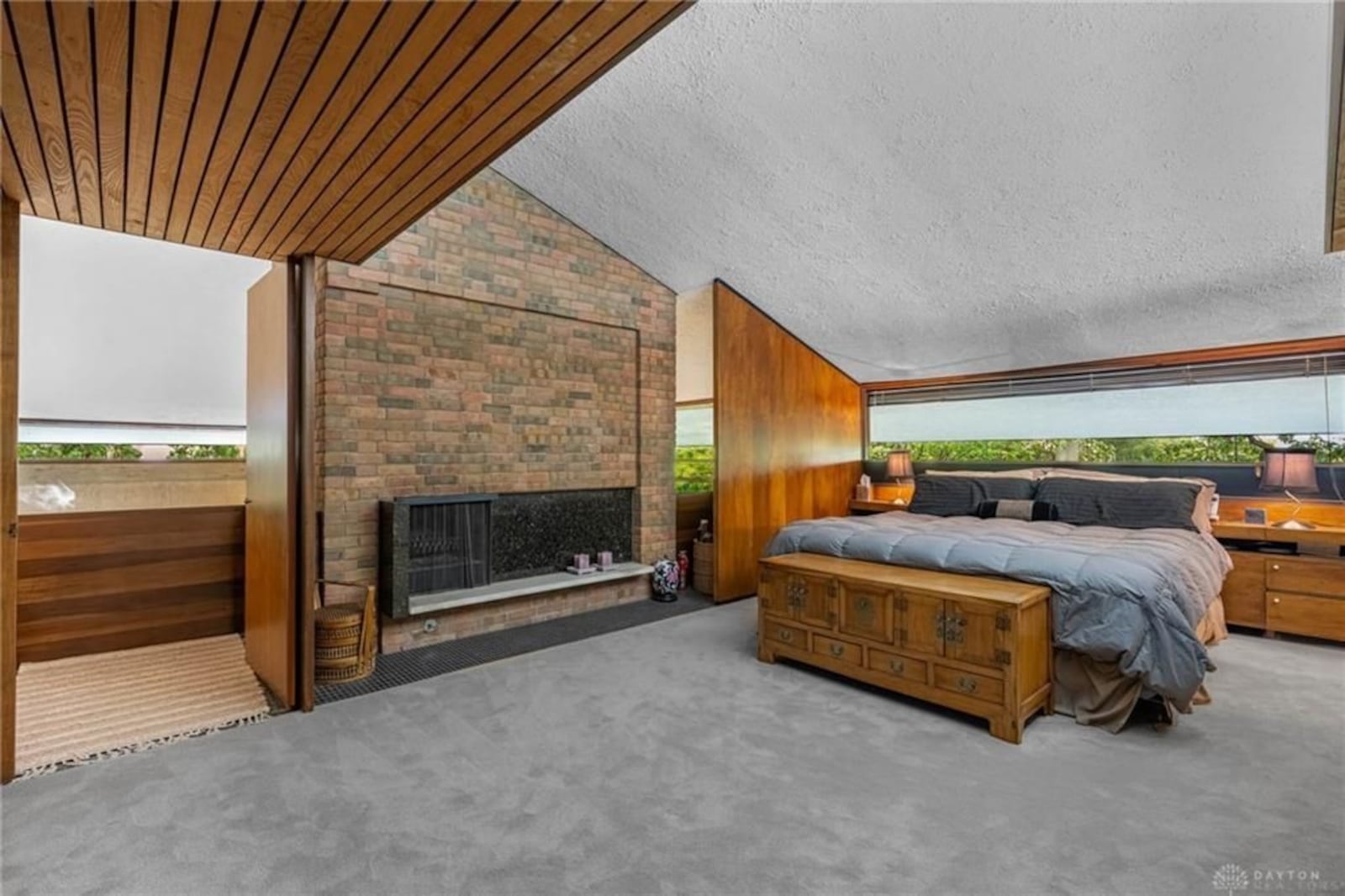 The primary bedroom suite has a woodburning fireplace with a brick wall, built ins and an ensuite bathroom. CONTRIBUTED