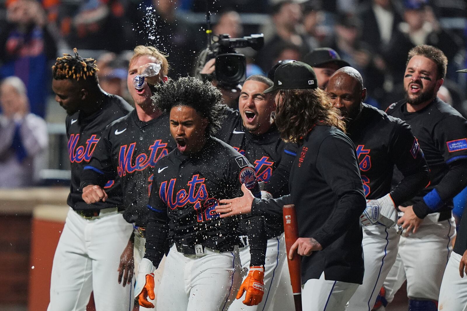 New York Mets' Francisco Lindor (12) celebrates with teammates after hitting a walk-off home run during the ninth inning of a baseball game against the St. Louis Cardinals Friday, April 18, 2025, in New York. (AP Photo/Frank Franklin II)