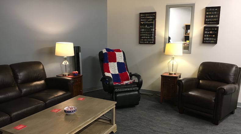 A lounge room with couches, chairs, televisions and a table is available for guests to use for relaxation during their visit. HOLLY SHIVELY