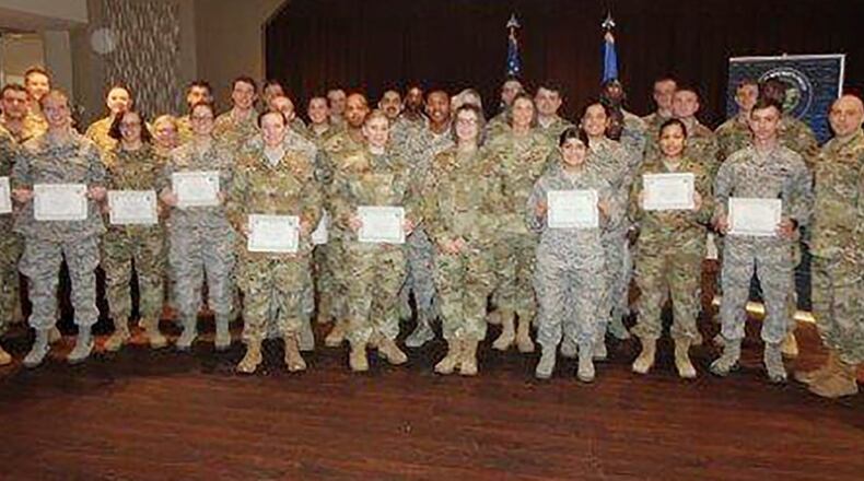 Col. Michael Phillips (second from back left), 88th Air Base Wing vice commander; Chief Master Sgt. Stanley Cadell (right), Air Force Materiel command chief; and Chief Master Sgt. Steve Arbona (second from right), 88th Air Base Wing command chief, celebrate the newest Team Wright-Patterson enlisted promotees during a ceremony at the Wright-Patterson Club Nov. 26. (U.S. Air Force photo/Thomas Lewis)