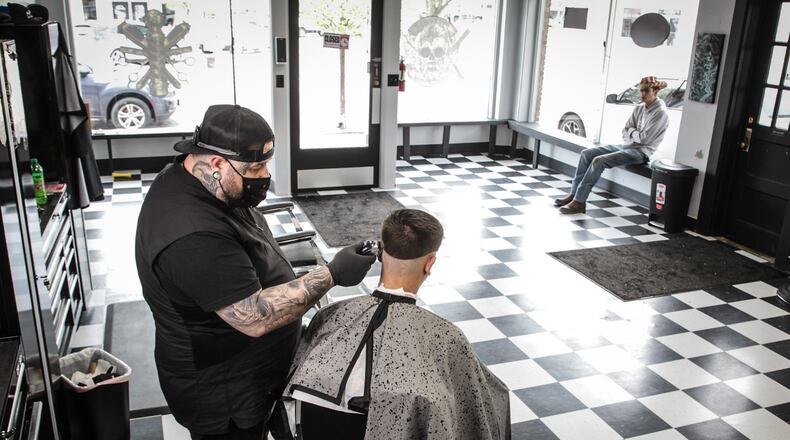 Fairborn barber, Dane Welch cuts Zach Cornett's hair. Cornett is from Yellow Springs. JIM NOELKER/STAFF