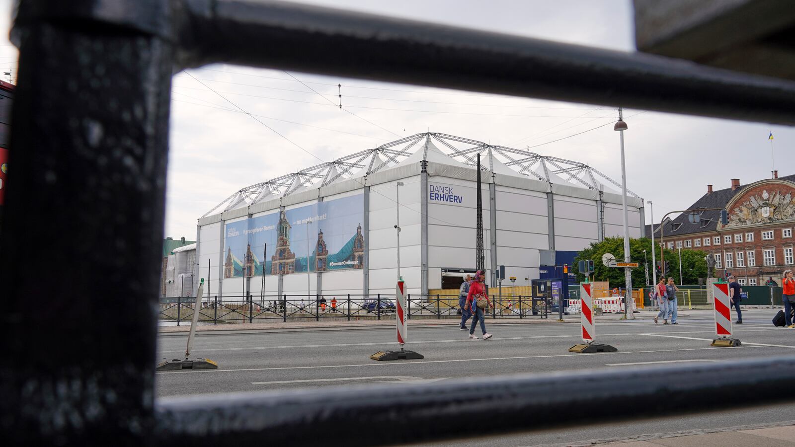 The fire-damaged Old Stock Exchange building is shrouded by a white construction tent in Copenhagen, Denmark, Monday, June 23, 2025. (AP Photo/James Brooks)