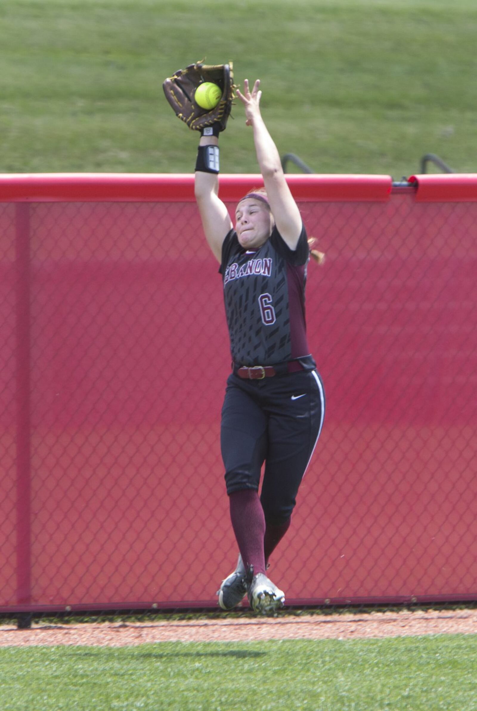 Lebanon left fielder Chloe Allen makes a catch near the warning track during Thursday’s Division I state semifinal against North Canton Hoover at Firestone Stadium in Akron. ROBERT ROSSITER/THE CANTON REPOSITORY