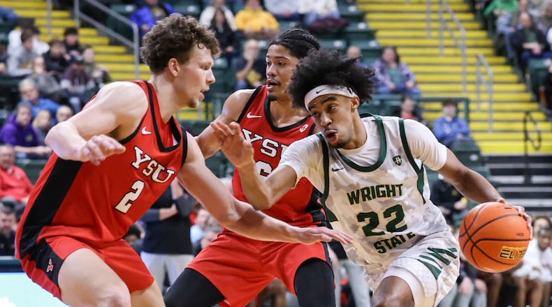 Wright State sophomore guard TJ Burch dribbles with pressure from Youngstown State's Rich Rolf (left) and Drew King (center) during a Horizon League game on Thursday, Jan. 15, 2026 at Ervin J. Nutter Center in Fairborn. BRYANT BILLING/STAFF