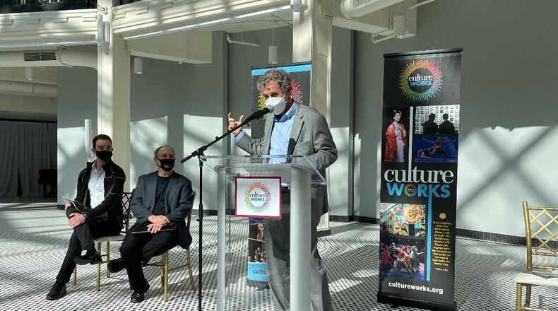 (left to right) Dayton Ballet company member Isaac Jones, Dayton Philharmonic Orchestra artistic director and conductor Neal Gittleman, and U.S. Senator Sherrod Brown discuss Shuttered Venue Operator Grants Oct. 12 in the Dayton Arcade Rotunda.