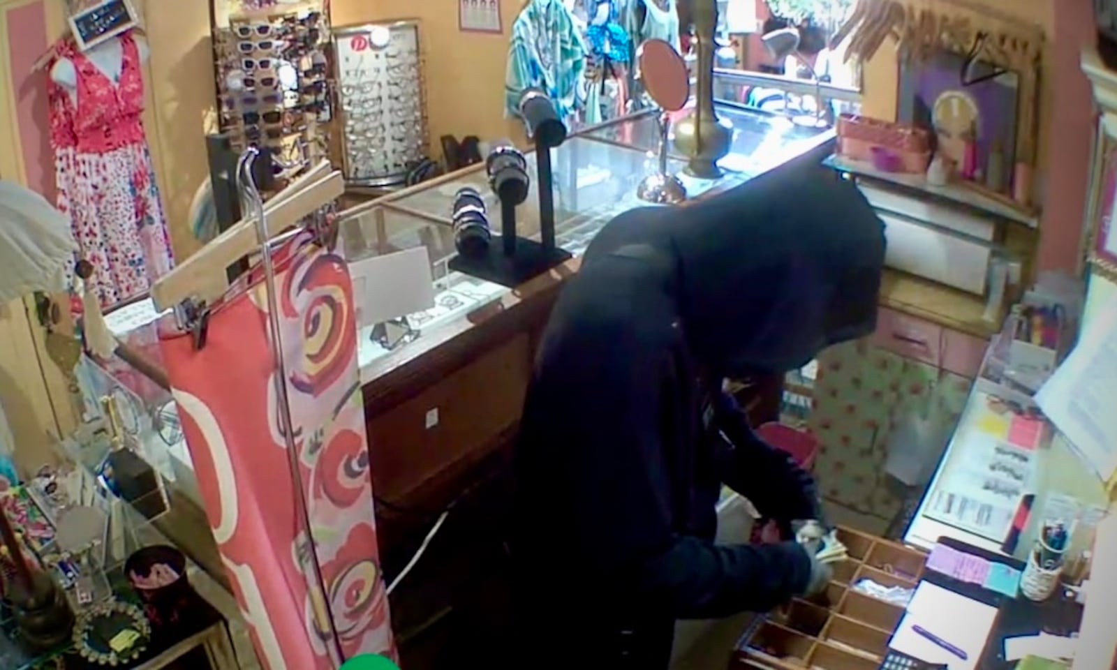 In this screenshot from CCTV footage provided by the business owner, a suspect robs the cash register of Heaven on Earth Emporium in Yellow Springs early Monday morning. The robbery is the latest in a series of break-ins targeting local businesses in the village. CONTRIBUTED