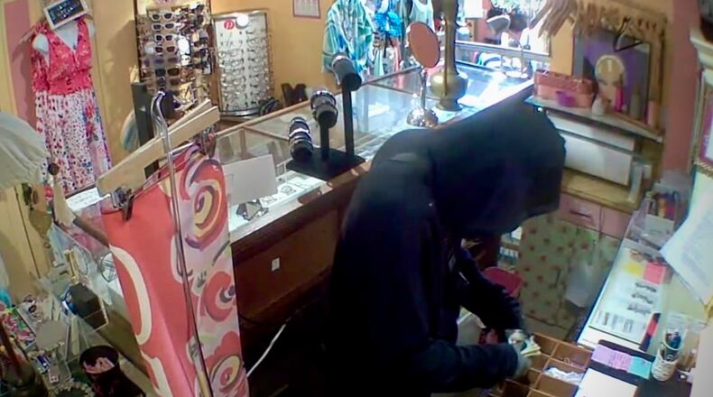 In this screenshot from CCTV footage provided by the business owner, a suspect robs the cash register of Heaven on Earth Emporium in Yellow Springs early Monday morning. The robbery is the latest in a series of break-ins targeting local businesses in the village. CONTRIBUTED
