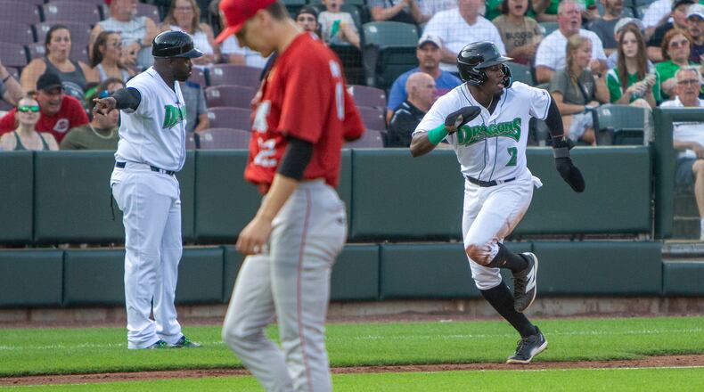 Dragons manager Vince Harrison Jr. points Jay Allen II toward home with the tying run in the third inning Thursday night at Day Air Ballpark. Allen stole third base and scored on a throwing error by Fort Wayne's catcher. Jeff Gilbert/CONTRIBUTED