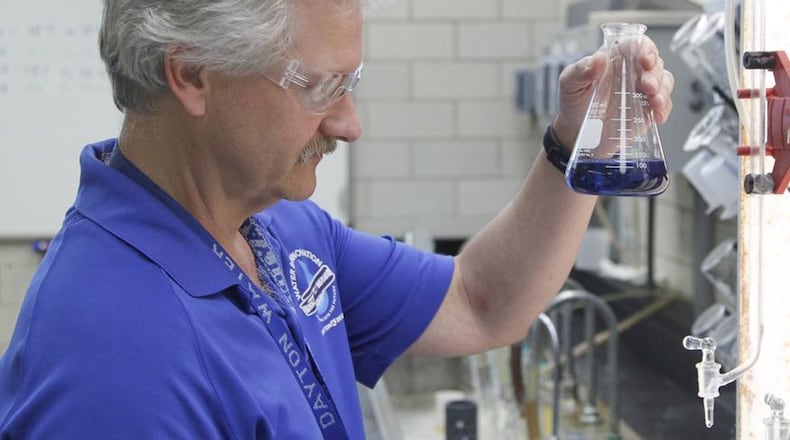 Tim Truman, a city of Dayton Department of Water research and control specialist, demonstrates how water is sampled for mineral content at the city’s Ottawa Water Treatment Plant. CHRIS STEWART / STAFF